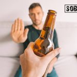 Can a recovering alcoholic drink again concept pic shows a man refusing a beer