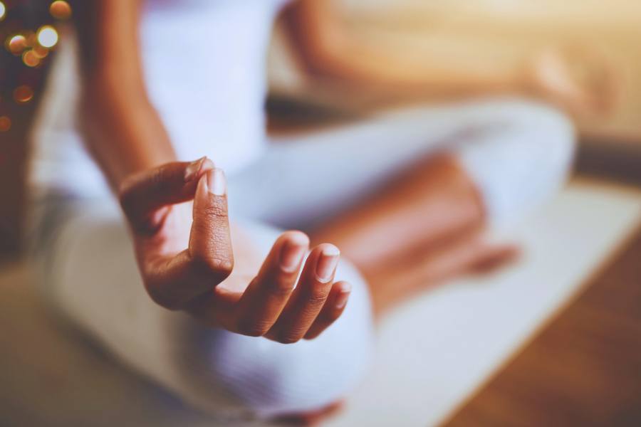 A woman meditating shows the concept of mindfulness in sobriety