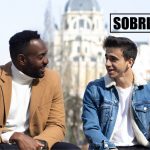 Two men talk on a bench to show the concept of how to become a sober companion