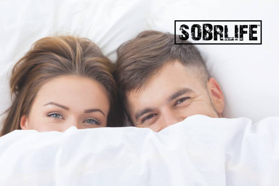 AA sex inventory concept pic from SOBRLIFE shows couple in bed with sheets pulled up to their eyes