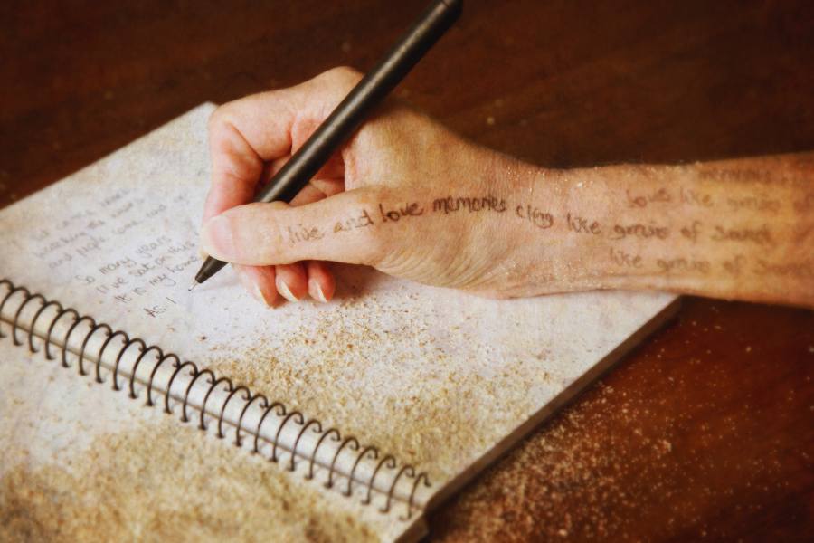 A stylized pen and hand writing shows the concept of recovery poetry